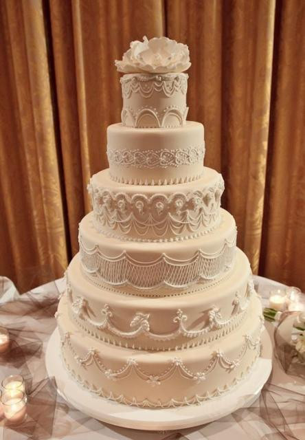 6 Tier Wedding Cakes
 6 tier wedding cake light tan color white flower on top JPG