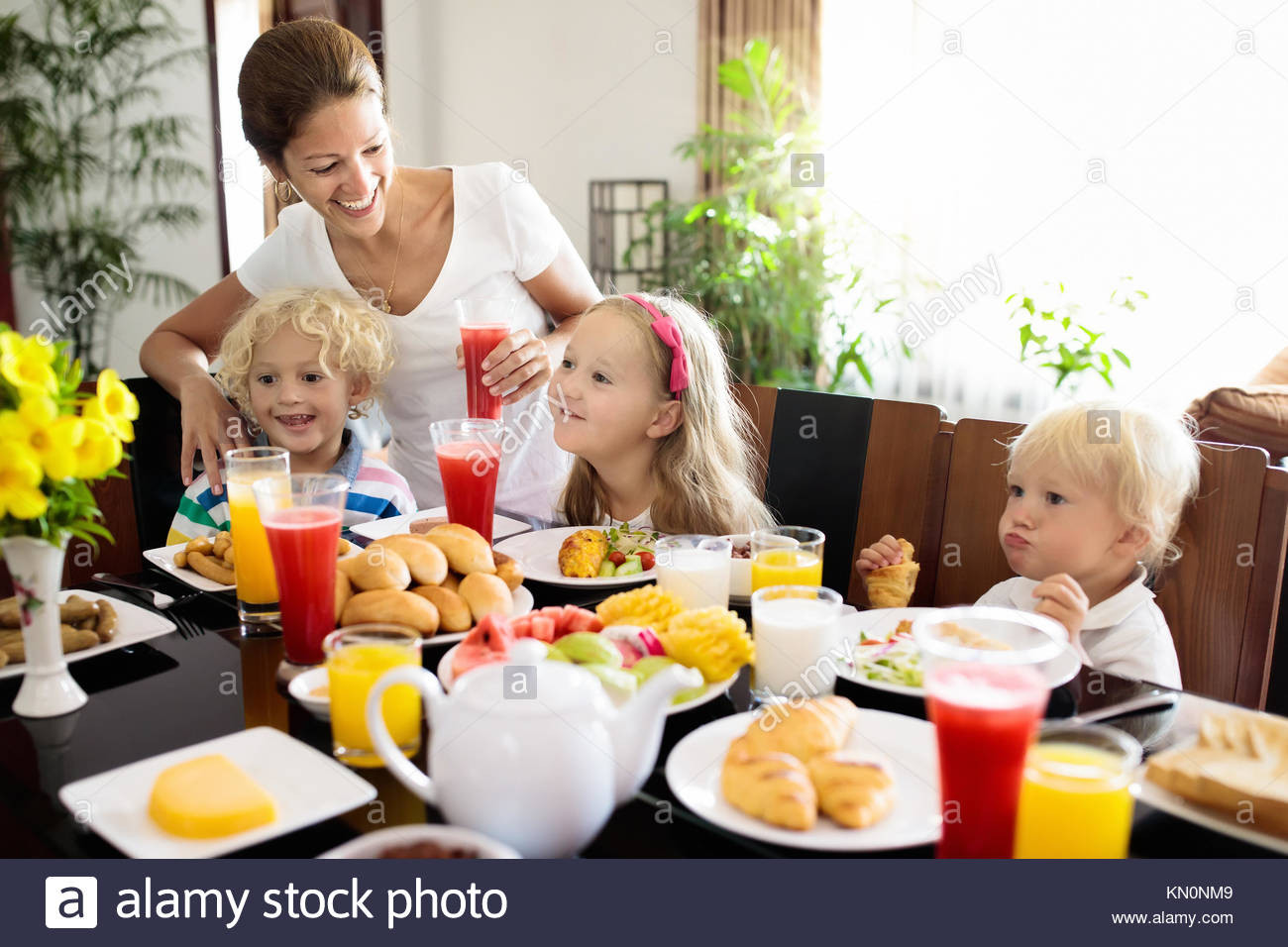 Healthy Breakfast At Home
 Healthy family breakfast at home Mother and kids eating