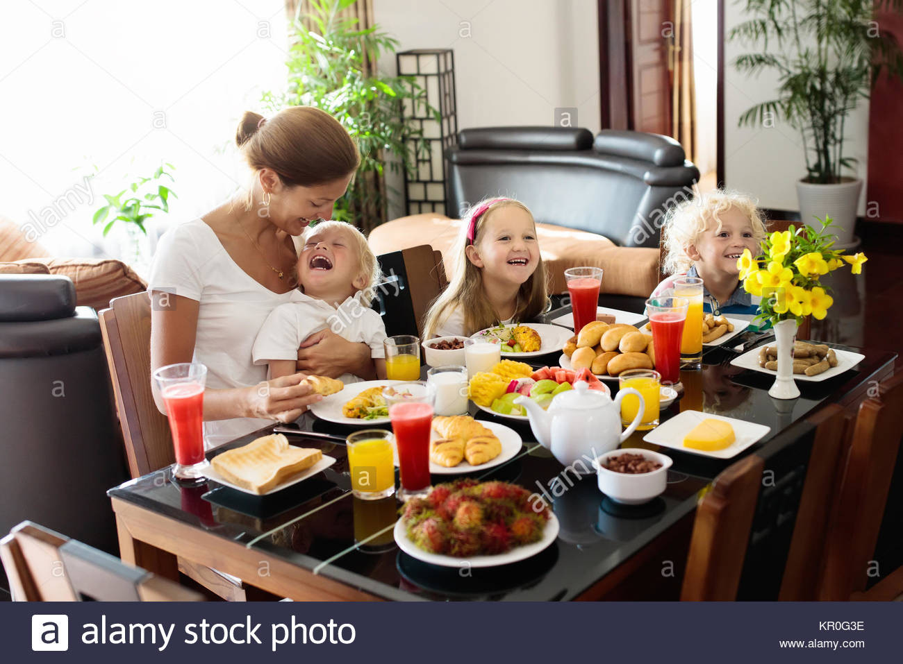 Healthy Breakfast At Home
 Healthy family breakfast at home Mother and kids eating