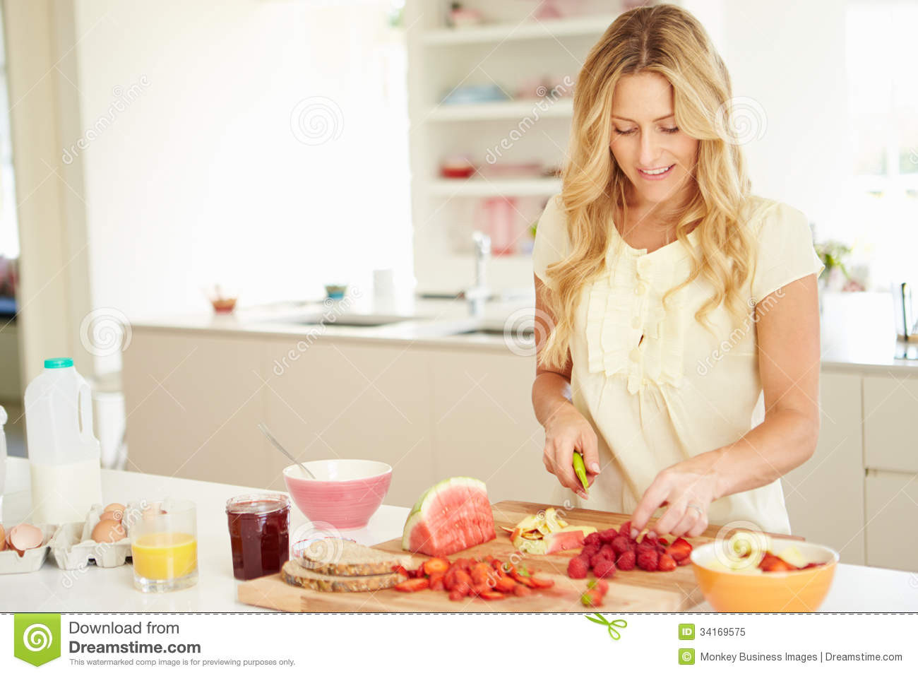 Healthy Breakfast For Women
 Woman Preparing Healthy Breakfast In Kitchen Stock Image