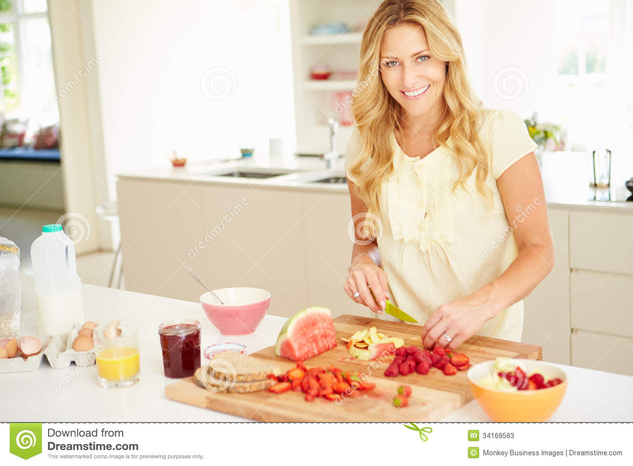 Healthy Breakfast For Women
 Woman Preparing Healthy Breakfast In Kitchen Stock Image