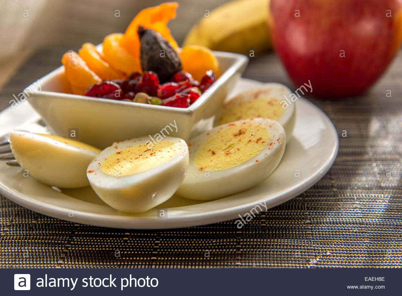Healthy Breakfast With Boiled Eggs
 Sliced hard boiled eggs and fruit healthy breakfast Stock