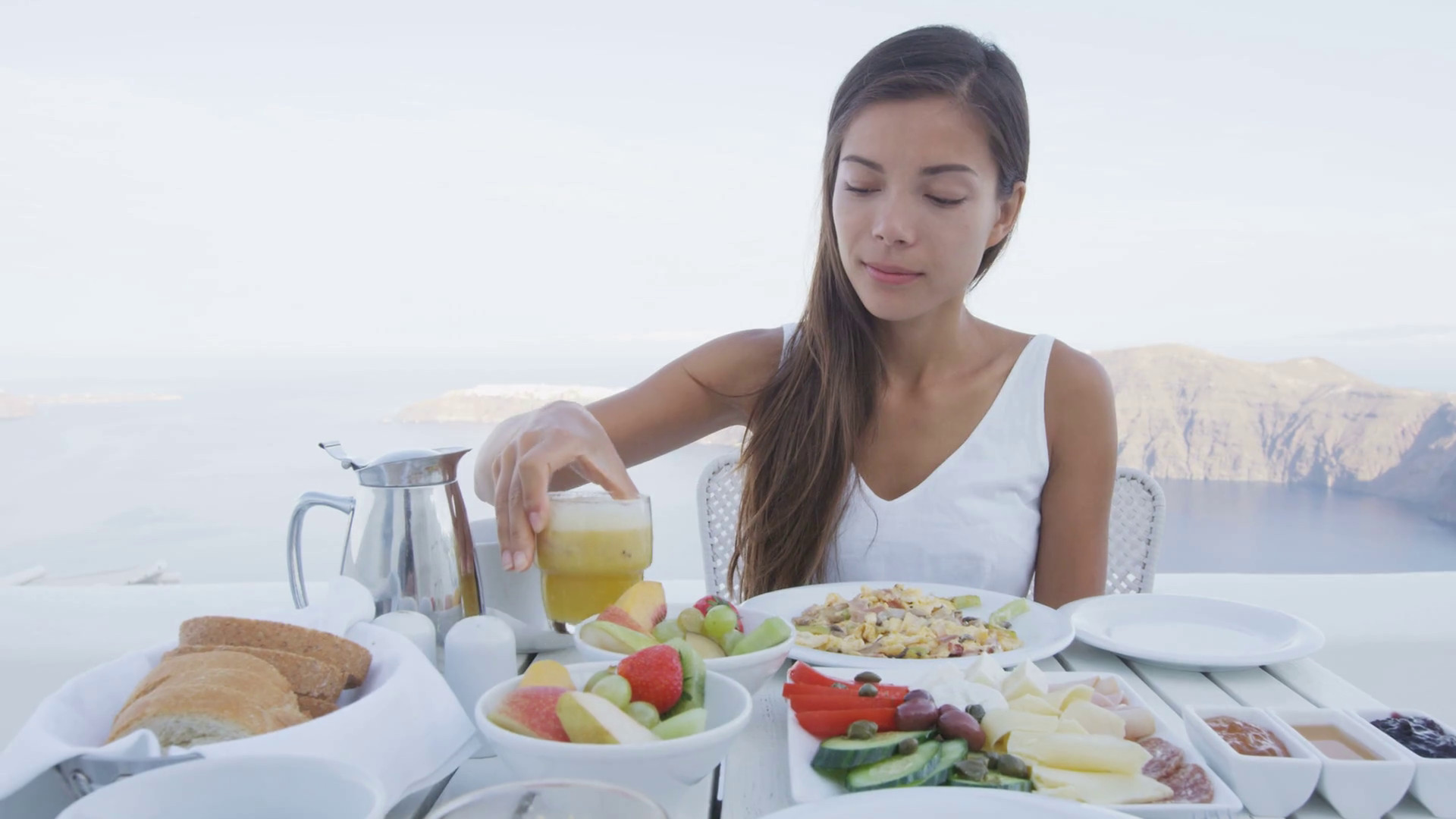 Healthy Eating Breakfast
 Asian woman eating breakfast Female tourist having glass