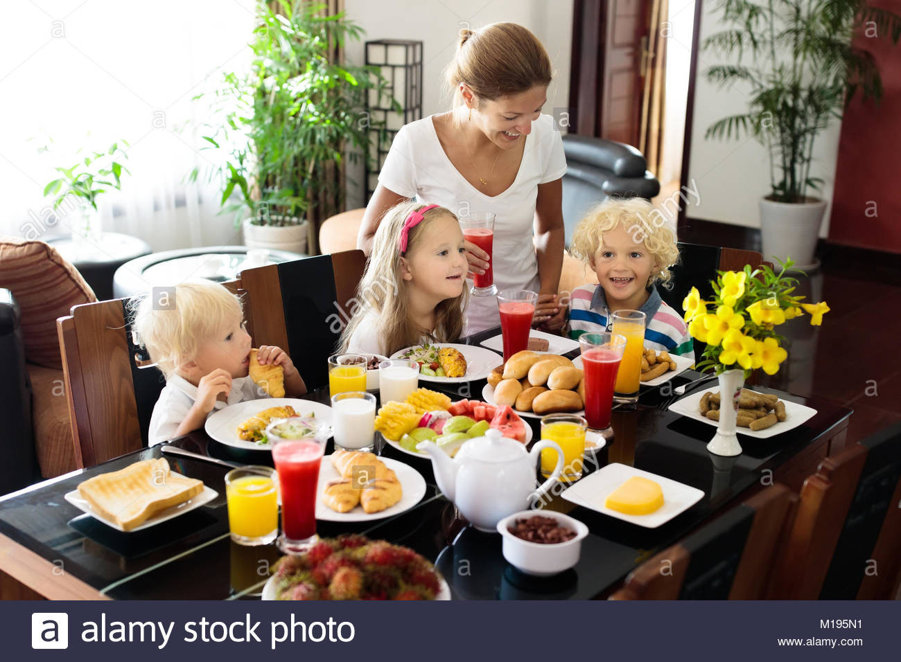 Healthy Family Breakfast
 Healthy family breakfast at home Mother and kids eating