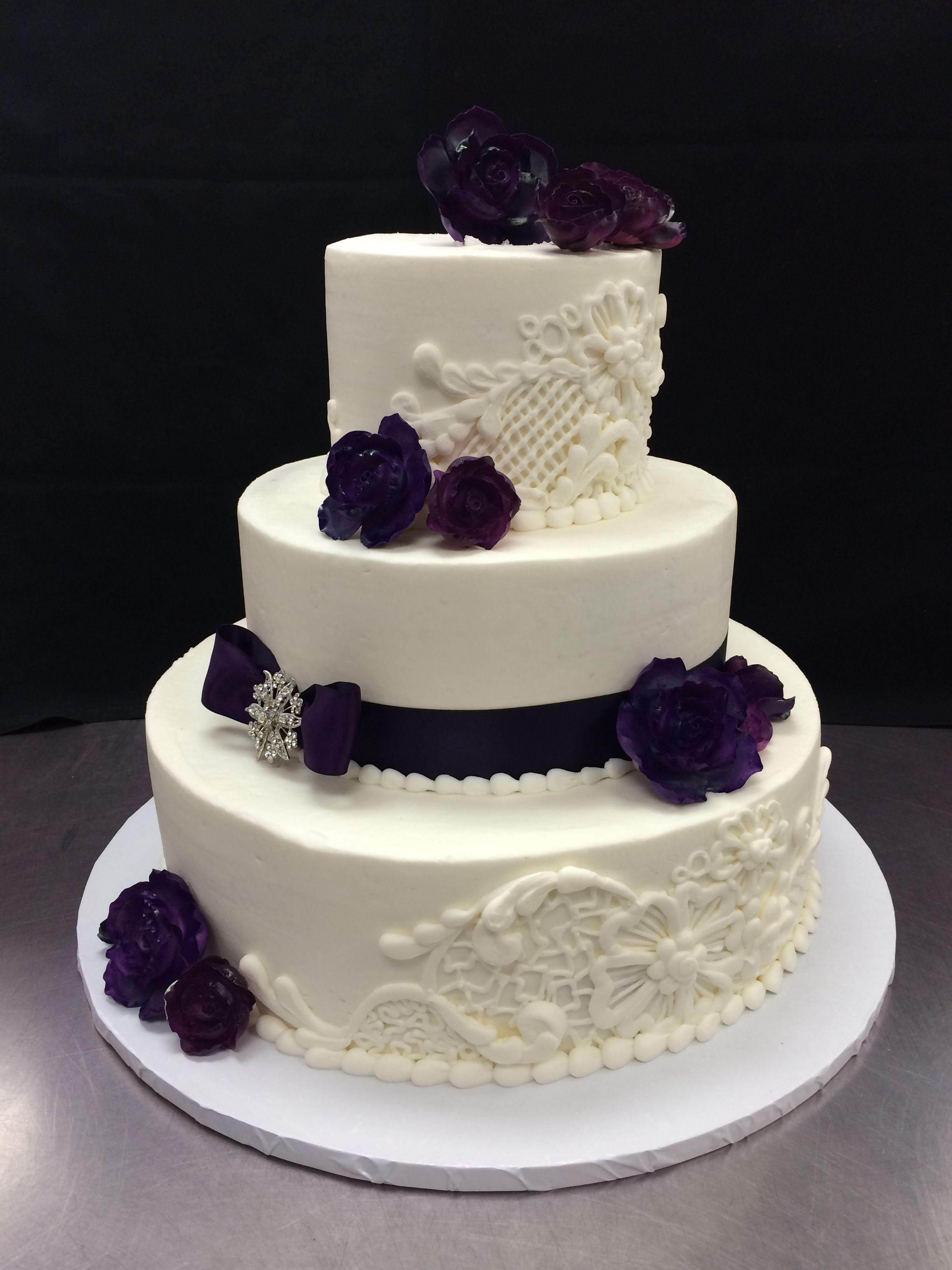 Hy Vee Wedding Cakes
 Hand piped lace details and Gumpaste Purple Roses Cake by