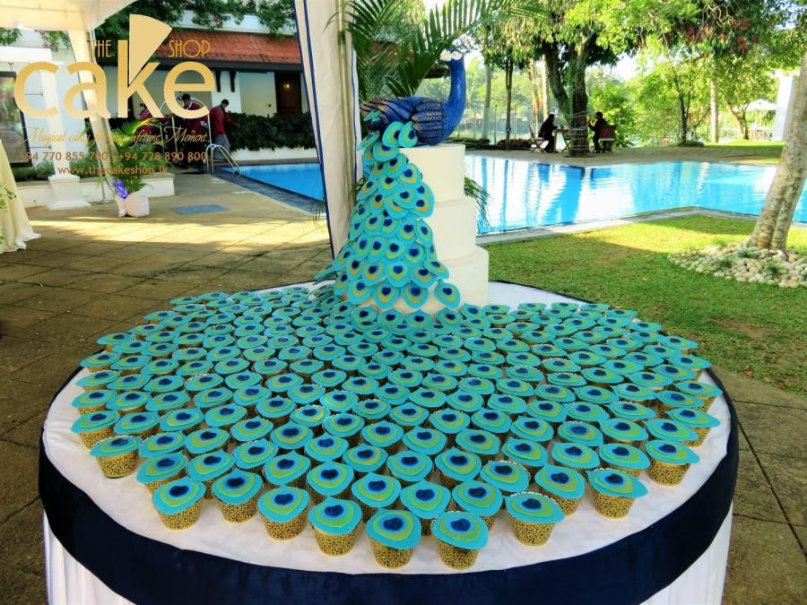 Peacock Wedding Cake With Cupcakes
 Peacock cupcake tower cake by The Cake Shop CakesDecor