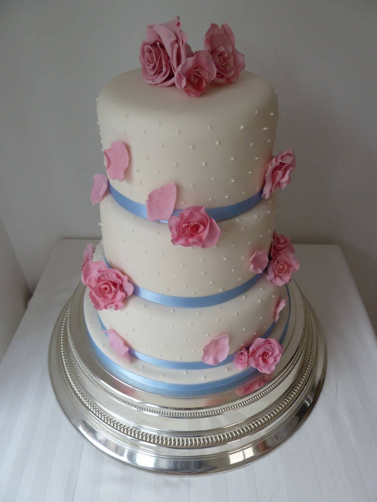 Pink And Blue Wedding Cakes
 three tier wedding cake with blue ribbon and pink roses