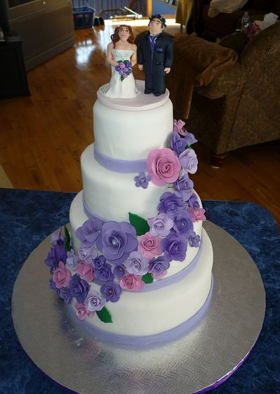 Pink And Purple Wedding Cakes
 Four tier round white wedding cake with cascading purple