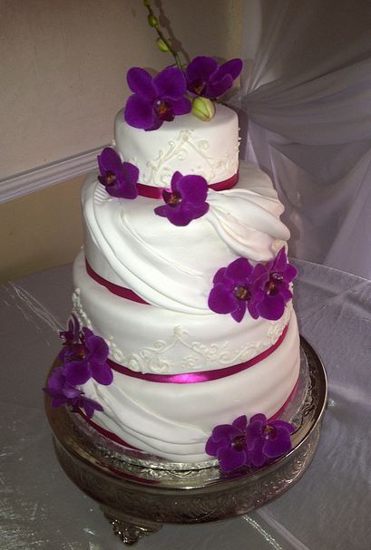 Purple And White Wedding Cakes
 Four tier white wedding cake with purple flower petals and