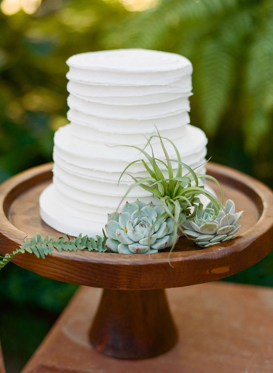 Simple 2 Tiered Wedding Cakes
 Simple two tier white wedding cake on a wooden stand