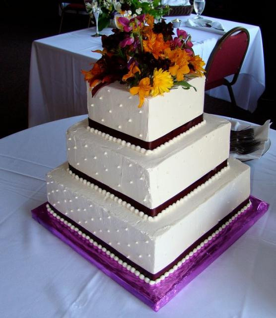 Square Tiered Wedding Cakes
 Three tier square white wedding cake with fresh flowers on