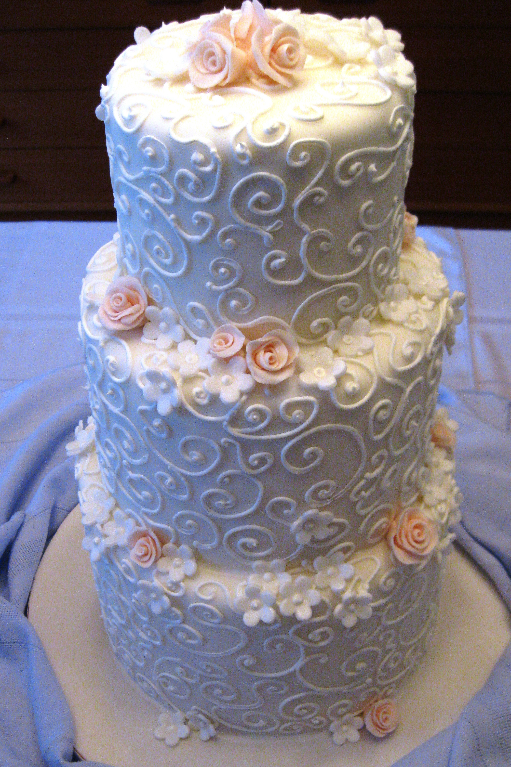 Swirl Wedding Cakes
 white swirls peach flowers wedding cake