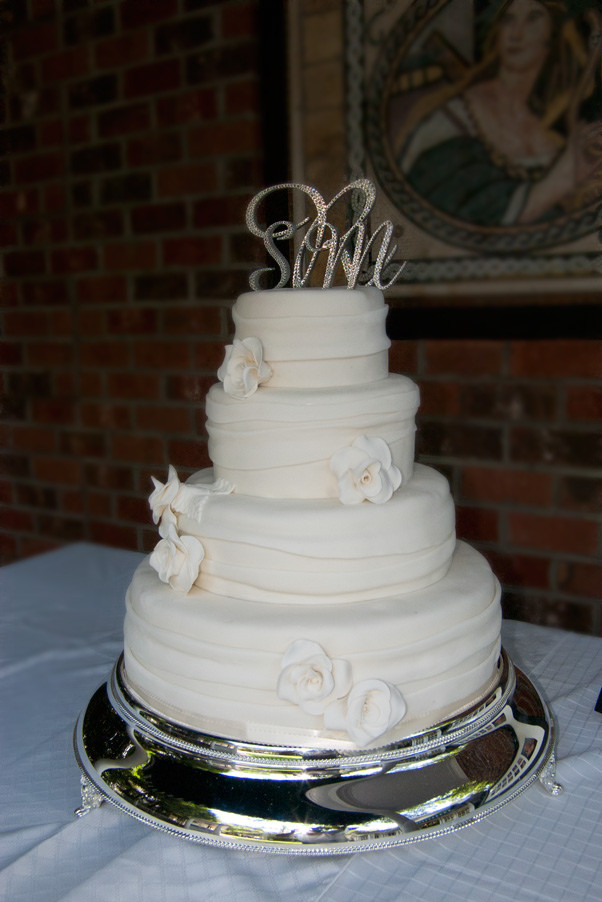 Wedding Cakes Asheville
 fondant ribbon wedding cake with white sugar roses • View