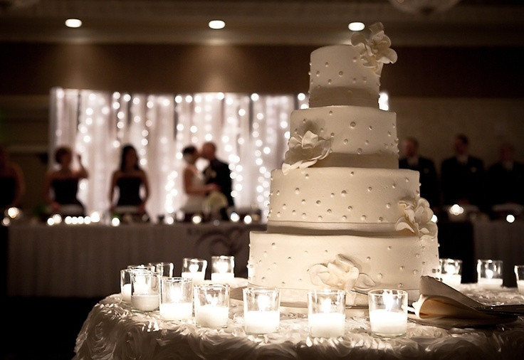 Wedding Cakes Lansing Mi
 Kissing with wedding cake in foreground Nobach