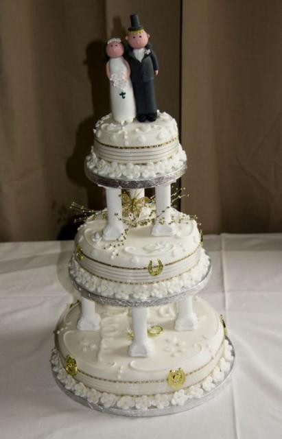 Wedding Cakes With Columns
 Round 3 tier ivory wedding cake with Roman columns between