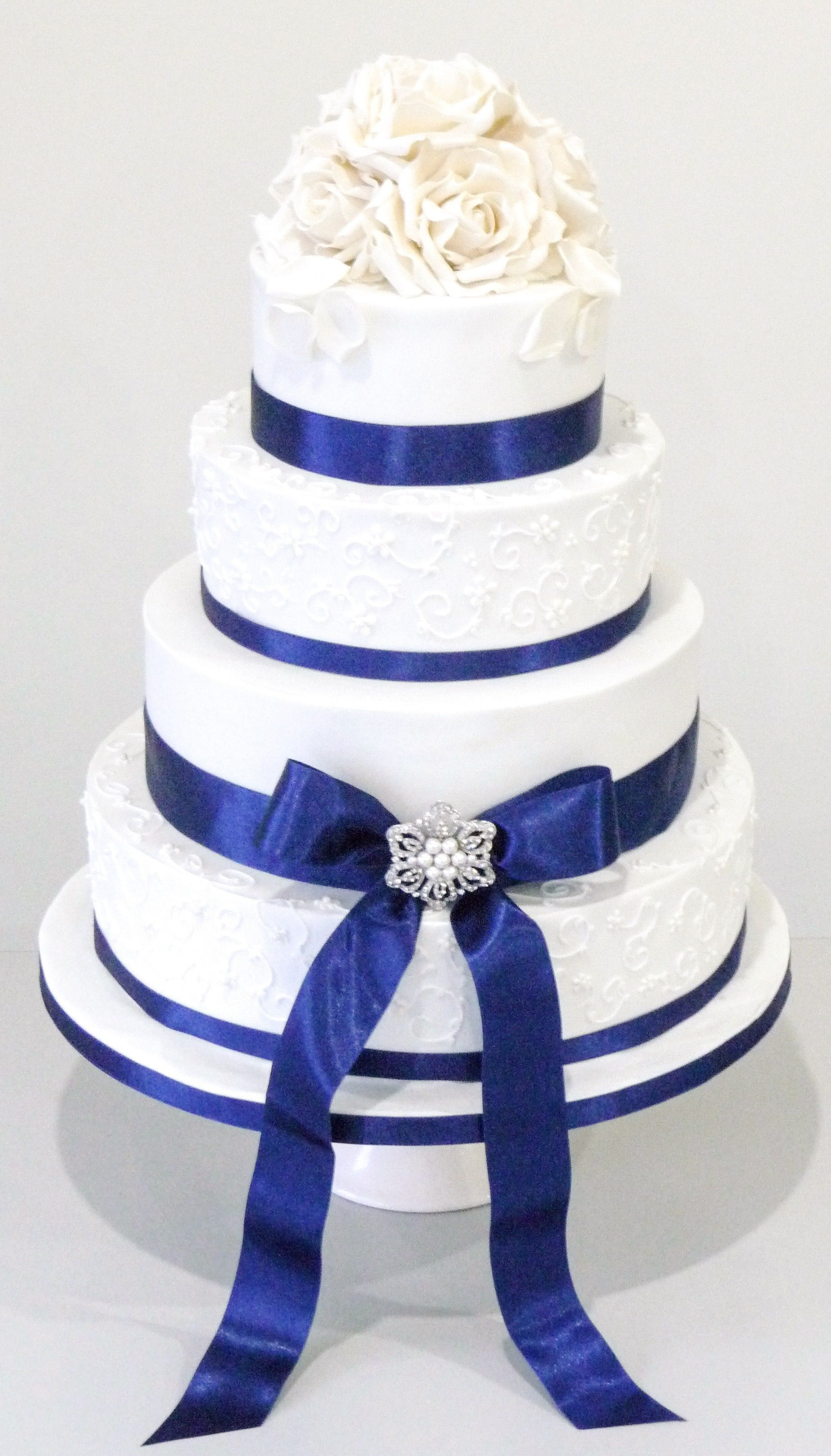 Wedding Cakes With Ribbons
 White sugar flowers on this 4 tier wedding cake with Royal