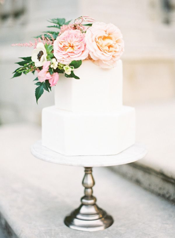 White Wedding Cake With Flowers
 Geometric white wedding cake with pastel flowers