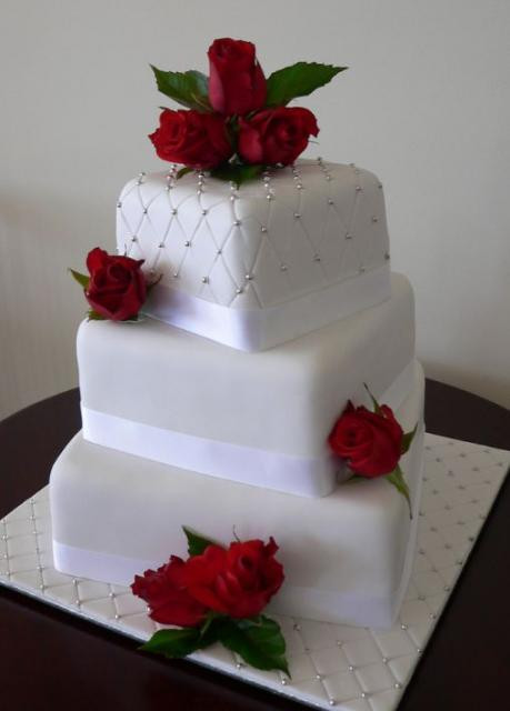White Wedding Cake With Red Roses
 Black And White Patterned Tiers Wedding Cake With Red